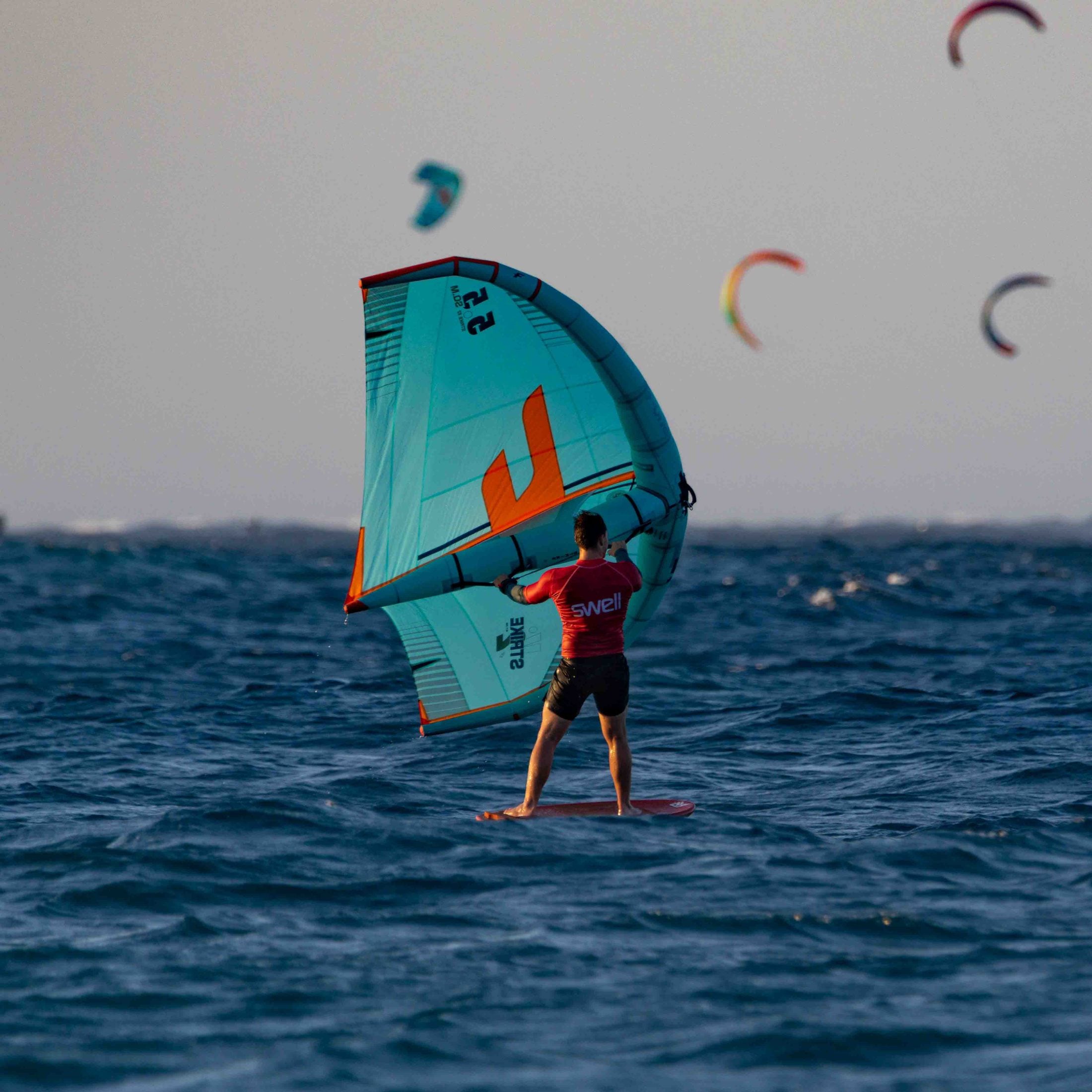 Wingfoiler riding in a Swell rashguard
